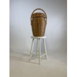 A wicker basket and a wooden stool painted white.