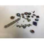 A collection of Scottish style brooches, a white metal panel bracelet. and other costume jewellery