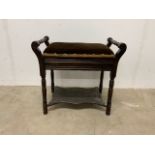 A mahogany piano stool with lift up lid and upholstered seat and shelf below.W:54cm x D:34cm x H: