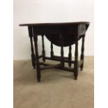 An 18th early 19th century oak gate leg table with side drawer. Extended forms an oval.W:90cm x D: