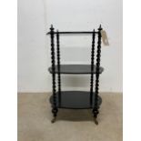 A black painted three tier trolley in the style of Gillows and Collier. Castors marked Cope