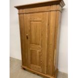 An antique pine wardrobe.W:100cm x D:42cm x H:181cm