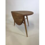 An Ercol side table with single drop leaf. W:36cm x D:61cm x H:41cmW:60cm x D:61cm x H:41cm (