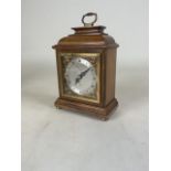 A mid 20th century walnut cased mantel clock by Eliot of London having a silvered dial with Roman