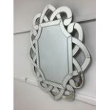 A modern pierced knot work wall mirror. W:74cm x D:2cm x H:90cm