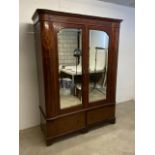 An Edwardian inlaid double wardrobe with bevelled mirror glass and bow fronted panel sides. Separate