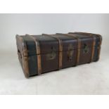 A travelling trunk with bent wood and metal detailing. Stamped British on lock. Leather handlesW: