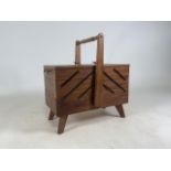 A oak cantilever sewing box with metal handles
