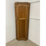 A light oak corner cupboard.W:65cm x D:45cm x H:183cm