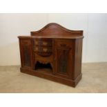 An Art nouveau style sideboard with wave back two side cupboards with metal lined drawer and two