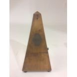 A Maelzel Paquet 1846-1915 walnut cased pyramid shaped metronome raised on bun feet, no. 438,300