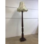 A mahogany standard lamp with turned column on circular base, with shade.W:35cm x D:35cm x H: