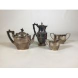 An electroplated four piece tea set with half reeded decoration.