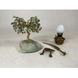 A green adventuring stone tree together will a small brass lamp, brass frog and a brass quill.
