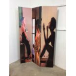 A canvas screen with pictures of pin-up girls and a woman in different stages of dressing. Double