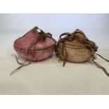 Two oriental leather and wicker hand sewn rice carriers.