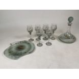 A set of six Romanian wine glasses with a matching decanter and glass wall clock