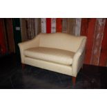 Two seater white sofa with oak legs