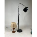 A black articulated lamp with adjustable head together with a wooden turned lamp. Black lamp: H: