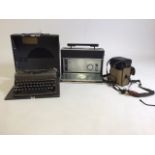 A Imperial Model T type writer, a Zenith radio and a Kodak Instamatic video camera.