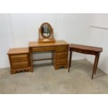 A modern pine desk by Singer furniture company Open Home also with a bedside chest and a mirror