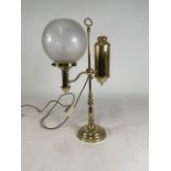 An Edwardian brass table lamp(converted) with frosted glass shade. H:58cm