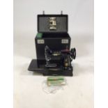 A Singer electric sewing machine. 222K. With instruction manual.
