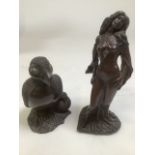 Two bronze effect models. A puffin and chick together with a scantily clad lady.