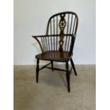 A 18th century Elm windsor wheel and stick back arm chair. W:58cm x D:46cm x H:101cm