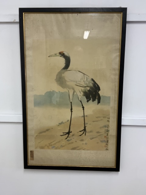 An oriental print of a crane with silk mount in black and gold frame. W:64cm x D:cm x H:102cm