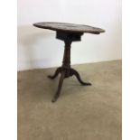 A Victorian oak revolving table with carved top and birdcage pedestal.W:66cm x D:66cm x H:64cm