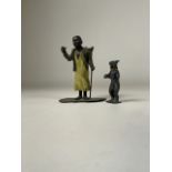 A late 19th century cold painted spelter figure of a North African boy carrying a basket together