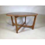 An Ercol style mid century circular light oak coffee tableW:90cm x D:90cm x H:48cm