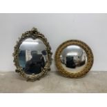 An oval and circular convex mirror with gilt frames.