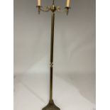 A brass candelabra style standard lamp with triangular base