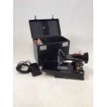 A Singer 222K electrical sewing machine. In box with accessories and instruction manual.