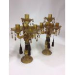 A pair of amber glass four branch table lustres with removable sconces, late 19th Century, each