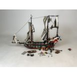A Lego 6286 Skulls Eye Schooner toy set from 1993. Compass, map, figurines and props present.