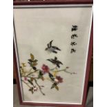 An Oriental embroidered framed silk panel of flora and fauna. W:28cm x H:39cm