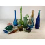 A collection of Italian coloured glass, jugs and bottles.