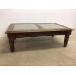 A stained pine coffee table with two rattan inserts and glass topped W:128cm x D:68cm x H:43cm
