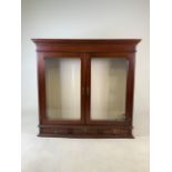 A glazed display wall cupboard with three drawers and wall paper lining. With key.