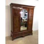 An Edwardian walnut veneered Italianate double wardrobe with large mirror glass pin door. Two large