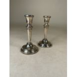 A pair of sterling silver candlesticks with weighted bases by Poston Products Ltd. London. 1962.
