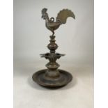A late 19th early 20th century Indian Deccan brass oil lamp with cockerel finial and seven spouted