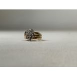 A marked 14k gold and diamond cluster ring.. Shank marked Fortune 14k. 5.6g. Size M.