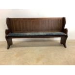 A pine pew with upholstery seat and studded finish. W:183cm x D:45cm x H:94cm