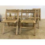 A collection of pine slatted folding chairs marked B and E Exeter. (8) some spare parts. W:50cm x