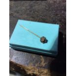 A gold and diamond set tie pin marked 15ct .1.8g.