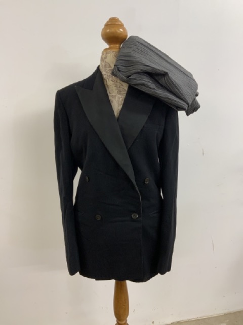 A mens dinner jacket by Montague Burton, London. With a pair of pinstripe trousers. Jacket: Chest